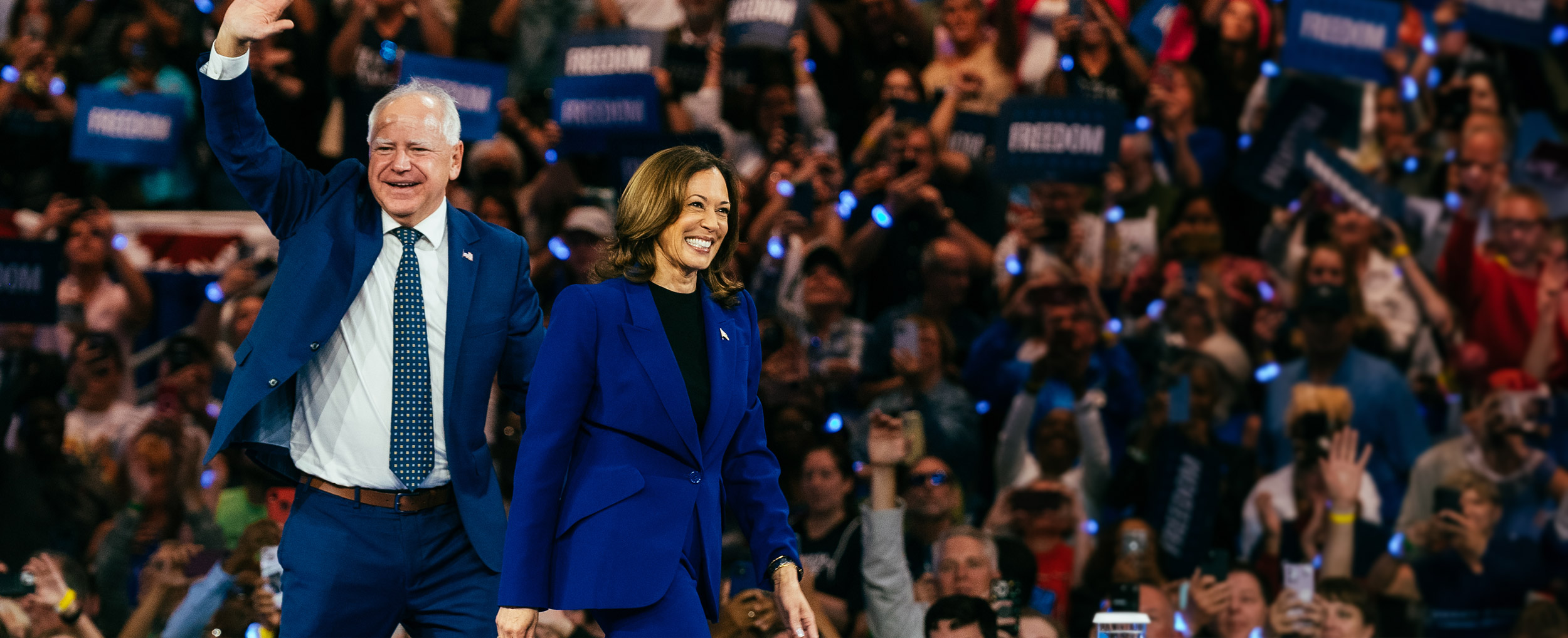 Vice President Harris and Governor Walz addressing a large crowd of supporters at a rally