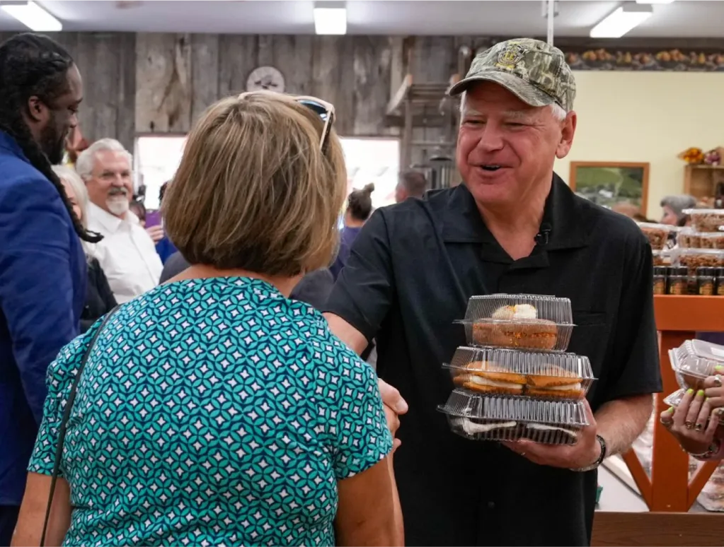 Tim Walz shaking a woman's hand